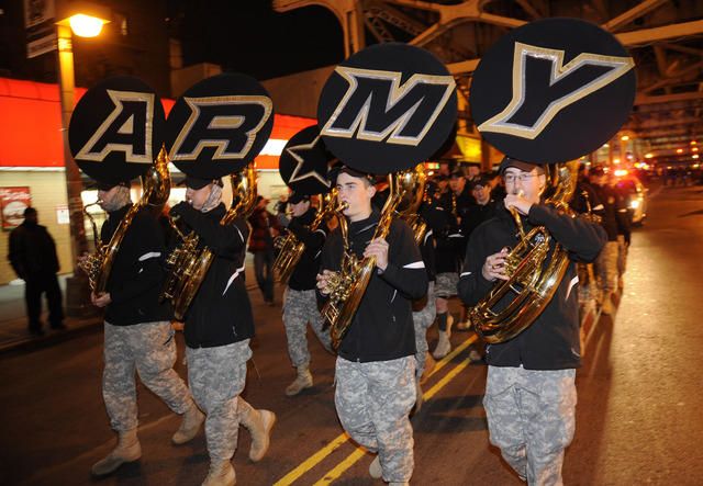 The Army band marches up River Avenue